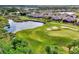 Aerial view of community with houses, golf course, and pond at 4259 Whispering Oaks Dr, North Port, FL 34287