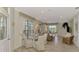 Bright dining area with wood table and white chairs, offering a view of the backyard at 4259 Whispering Oaks Dr, North Port, FL 34287