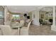 Bright dining area with glass table and built-in workspace at 4259 Whispering Oaks Dr, North Port, FL 34287