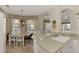 Bright dining area with a table for six, and adjacent to the kitchen at 4259 Whispering Oaks Dr, North Port, FL 34287