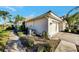 Side view of villa showcasing garage and landscaping at 4259 Whispering Oaks Dr, North Port, FL 34287