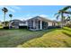 Charming house exterior with well-manicured lawn and screened patio at 4259 Whispering Oaks Dr, North Port, FL 34287