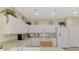 White kitchen with ample counter space and modern appliances at 4259 Whispering Oaks Dr, North Port, FL 34287