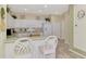 White kitchen with breakfast bar and ample cabinet space at 4259 Whispering Oaks Dr, North Port, FL 34287