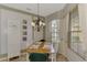 Charming kitchen nook with a wooden table and green chairs at 4259 Whispering Oaks Dr, North Port, FL 34287