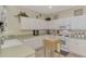 Bright eat-in kitchen with white cabinets, granite countertops, and tile floors at 4259 Whispering Oaks Dr, North Port, FL 34287
