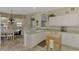 Open kitchen with a breakfast nook, white cabinets, and a view to the dining area at 4259 Whispering Oaks Dr, North Port, FL 34287