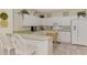 White kitchen with breakfast bar and stainless steel appliances at 4259 Whispering Oaks Dr, North Port, FL 34287