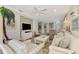 Bright and airy living room with ample seating and large windows at 4259 Whispering Oaks Dr, North Port, FL 34287
