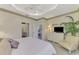 Main bedroom with king bed, sitting area, and access to a private bathroom at 4259 Whispering Oaks Dr, North Port, FL 34287