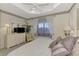 Main bedroom with king bed, window seat, and a large window offering natural light at 4259 Whispering Oaks Dr, North Port, FL 34287