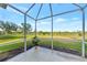 Relaxing screened porch overlooking a lush green space at 4259 Whispering Oaks Dr, North Port, FL 34287