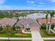 Aerial view of a beautiful home on a lake with lush landscaping at 430 Marsh Creek Rd, Venice, FL 34292