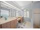 Large bathroom with double vanity, shower, and a garden tub at 430 Marsh Creek Rd, Venice, FL 34292