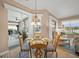 Bright dining area with glass table and four chairs, view of backyard at 430 Marsh Creek Rd, Venice, FL 34292