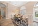 Elegant dining room with a chandelier, hardwood floors, and adjacent kitchen access at 430 Marsh Creek Rd, Venice, FL 34292