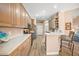 Modern kitchen with light wood cabinets, ample counter space, and breakfast bar at 430 Marsh Creek Rd, Venice, FL 34292