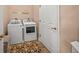 Convenient laundry room with washer, dryer, and storage at 430 Marsh Creek Rd, Venice, FL 34292