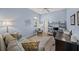 Home office with a comfortable couch, desk, and natural light at 430 Marsh Creek Rd, Venice, FL 34292