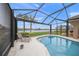 Relaxing pool and spa with screened enclosure and lake view at 430 Marsh Creek Rd, Venice, FL 34292