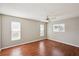 Simple bedroom with wood-look floors and ceiling fan at 441 N Shore Dr, Osprey, FL 34229