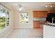 Eat-in kitchen with wood cabinets, granite countertops, and a view of the backyard at 441 N Shore Dr, Osprey, FL 34229