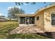 Screened patio with paver stones and adjacent lawn at 441 N Shore Dr, Osprey, FL 34229