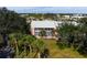 Aerial view of condo building with lush landscaping and palm trees at 458 Cerromar Rd # 483, Venice, FL 34293