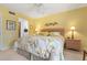 Spacious bedroom with king bed, ceiling fan and en-suite bathroom access at 458 Cerromar Rd # 483, Venice, FL 34293