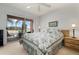 Bedroom with floral bedding and access to balcony at 458 Cerromar Rd # 483, Venice, FL 34293