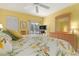 King-size bedroom with tropical bedding, dresser, and access to balcony at 458 Cerromar Rd # 483, Venice, FL 34293