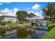 Community clubhouse with covered bridge over water feature at 458 Cerromar Rd # 483, Venice, FL 34293