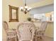 Dining area with glass table and wicker chairs at 458 Cerromar Rd # 483, Venice, FL 34293