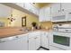 Bright kitchen with white cabinets, wood countertops, and modern appliances at 458 Cerromar Rd # 483, Venice, FL 34293