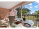 Screened lanai with glass table and chairs, offering a view of the water at 458 Cerromar Rd # 483, Venice, FL 34293