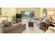 Living room with sliding doors to patio and neutral decor at 458 Cerromar Rd # 483, Venice, FL 34293