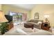 Living room with sliding doors to patio and neutral decor at 458 Cerromar Rd # 483, Venice, FL 34293