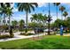 Vibrant town square with palm trees, clock tower, and shops at 458 Cerromar Rd # 483, Venice, FL 34293