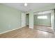 Bedroom with mirrored closet doors and wood flooring at 460 Base E Ave # 122, Venice, FL 34285