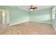 Bright bedroom with light walls and laminate flooring at 460 Base E Ave # 122, Venice, FL 34285