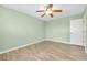 Bright bedroom with ceiling fan and wood flooring at 460 Base E Ave # 122, Venice, FL 34285