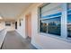 Condo building entrance with peach door and balcony at 460 Base E Ave # 122, Venice, FL 34285