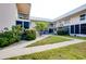 Courtyard of a two-story condo building with walkway at 460 Base E Ave # 122, Venice, FL 34285