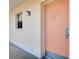 Condo building entrance with peach door and window at 460 Base E Ave # 122, Venice, FL 34285