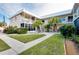 Two-story condo building with landscaped grounds and walkway at 460 Base E Ave # 122, Venice, FL 34285