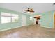 Open living room and kitchen with laminate floors and ceiling fan at 460 Base E Ave # 122, Venice, FL 34285