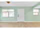 Bright living room with light walls, wood floors and entryway at 460 Base E Ave # 122, Venice, FL 34285