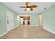 Open living room and kitchen with laminate floors and ceiling fan at 460 Base E Ave # 122, Venice, FL 34285