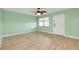 Living room with light green walls and ceiling fan at 460 Base E Ave # 122, Venice, FL 34285
