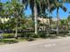 Scenic street view with lush landscaping and palm trees at 460 Base E Ave # 122, Venice, FL 34285